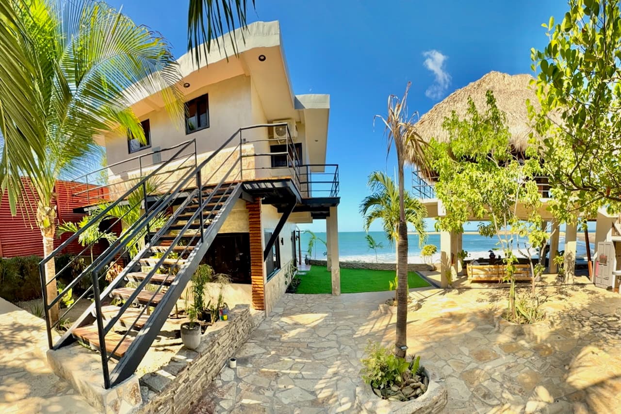 Exterior view of Miramar SurfCamp showing access to the Wave View Room near the ocean